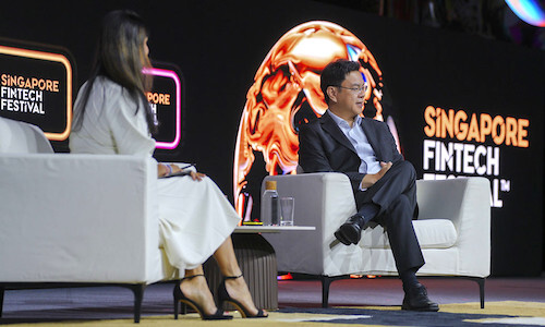 Speakers in conversation on stage at Singapore FinTech Festival